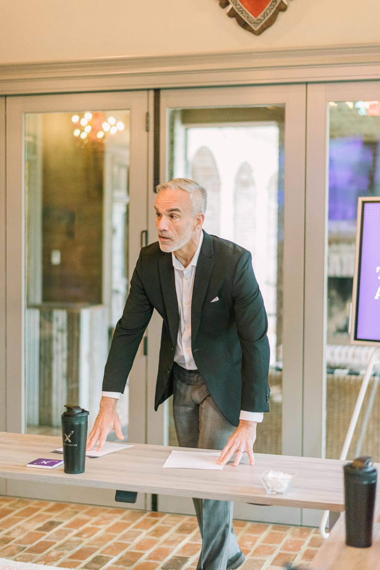 An EXM coach leading a working session with a client leadership team